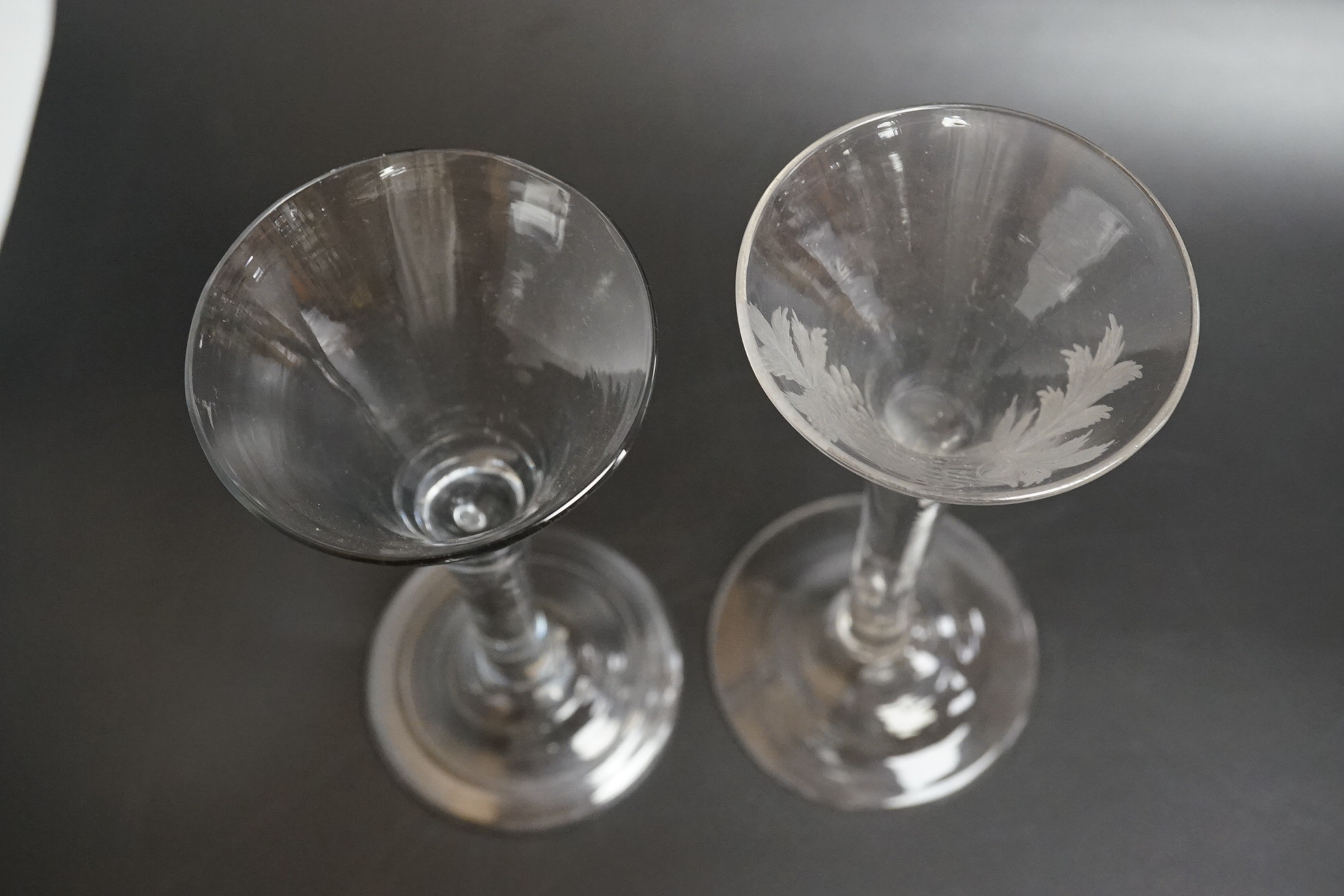 Two 18th century glass wine flutes, one with folded foot, tallest 16cm high